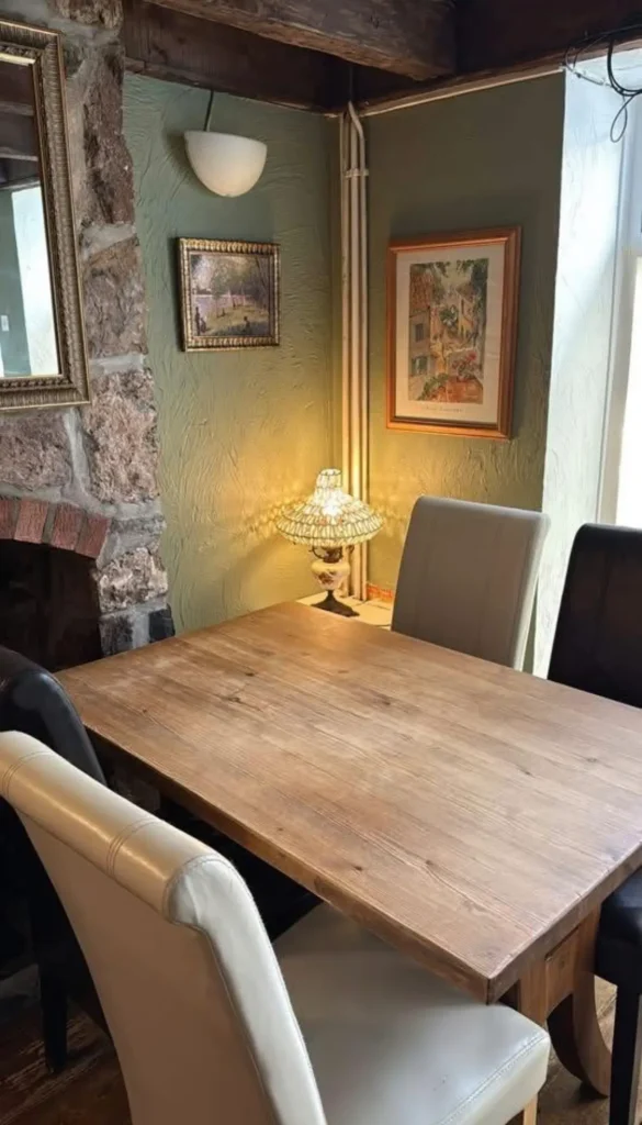 A cosy corner table with nice lamp lighting in front of a brick fireplace in Laws Street Diner